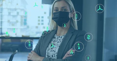 Businesswoman in mask surrounded by eco-friendly digital interface