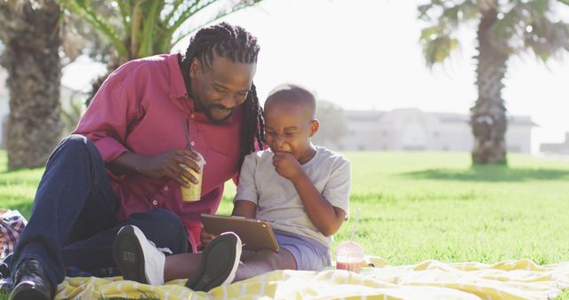 Father and Son Enjoying Tablet at Outdoor Picnic - Download Free Stock Images Pikwizard.com