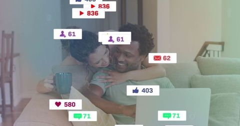 Smiling Couple Using Laptop with Digital Communication Icons