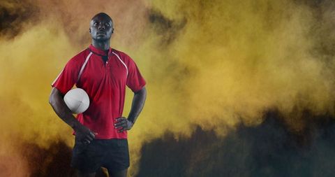Confident African American Rugby Player with Ball and Vibrant Smoke Background