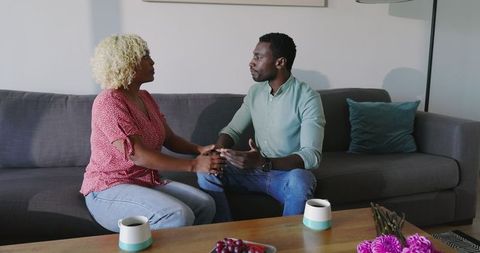 Couple Engaging in Deep Conversation on Living Room Sofa