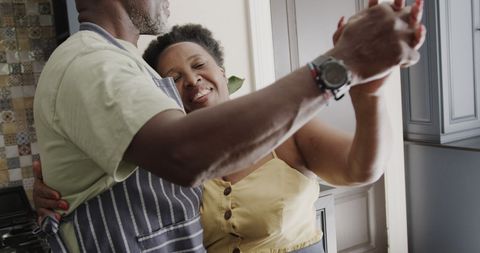Senior African American Couple Dancing in Kitchen