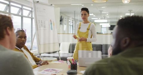 Professional Woman Presenting to Team in Modern Office Setting