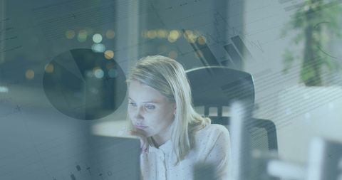 Businesswoman Analyzing Data Late at Night at Office