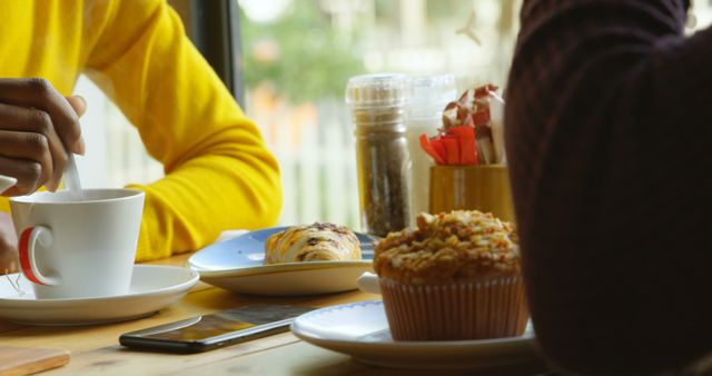 Friends Enjoying Coffee and Pastries at Cafeteria Table - Download Free Stock Images Pikwizard.com