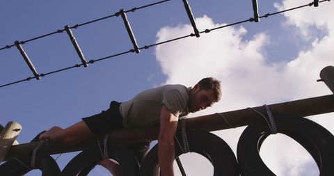 Athletic Man Conquering Outdoor Obstacle Course with Determination