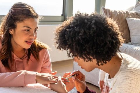 Sunlit at-home manicure with diverse friends sharing cozy self-care and bonding moment