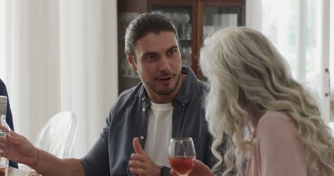 Man engaging in conversation with woman at elegant wedding reception
