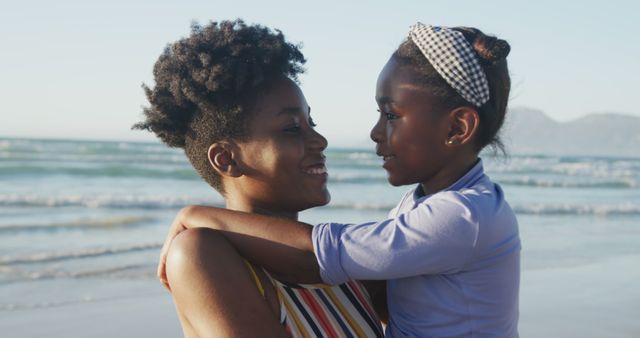 Mother and Daughter Embracing at Beach During Sunset - Download Free Stock Images Pikwizard.com