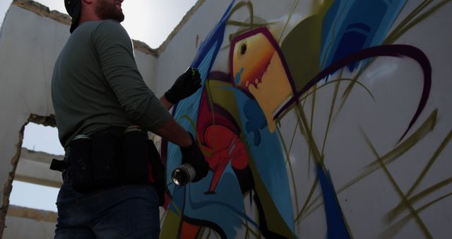 Graffiti Artist Creating Vibrant Urban Street Art on Wall - Download Free Stock Images Pikwizard.com