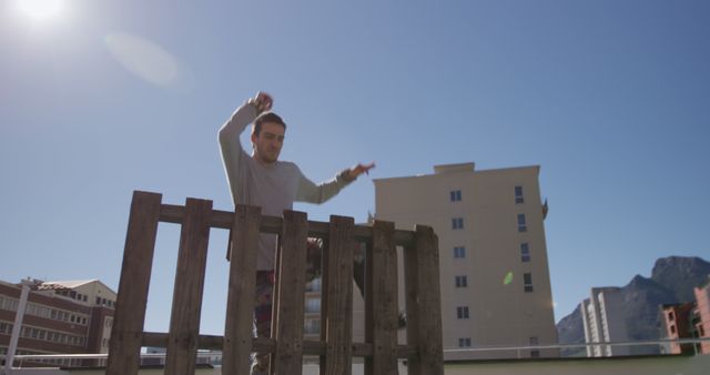 Urban Parkour Athlete Jumping on Rooftop in Cityscape - Download Free Stock Images Pikwizard.com