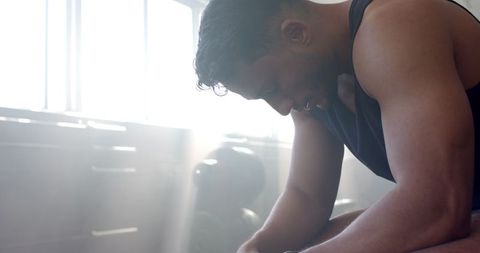 Man Resting after Intense Gym Workout wearing Smartwatch