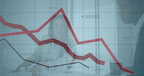 Businesswomen Analyzing Financial Graph and Data in Modern Office