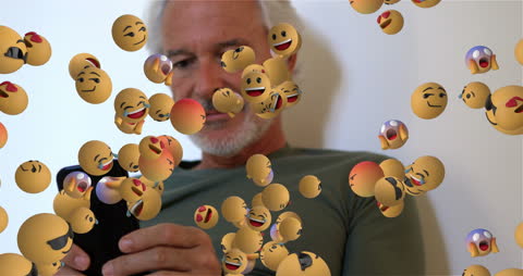 Senior Man Engaging with Emojis on Smartphone