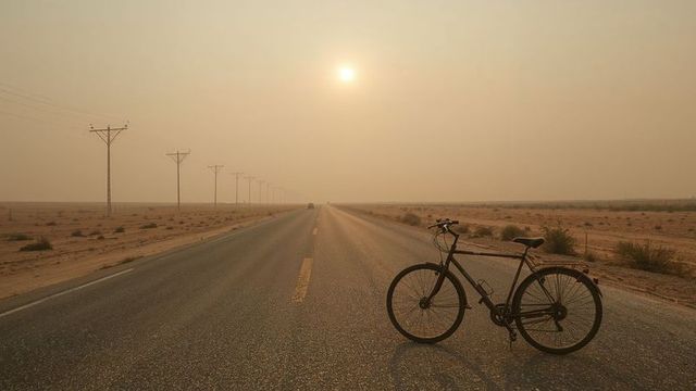 Solitary Bicycle on Desert Road at Misty Sunrise