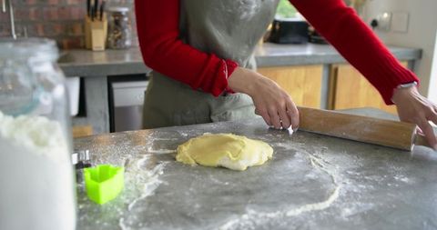 African American Baker Rolling Dough on Floured Metal Countertop Home Kitchen Baking