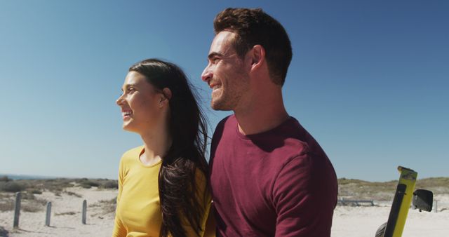 Smiling Young Couple Enjoying Sunny Beach Day by Ocean - Download Free Stock Images Pikwizard.com