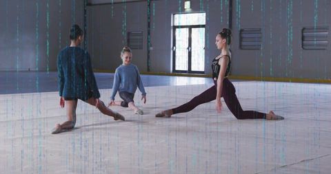 Three ballet dancers practicing low splits in bright rink studio emphasizing flexibility and focus