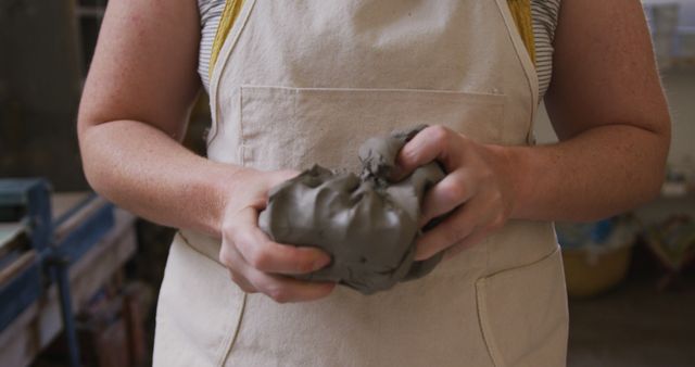 Portrait of female potter wearing face mask and apron working on clay at pottery studio - Download Free Stock Photos Pikwizard.com