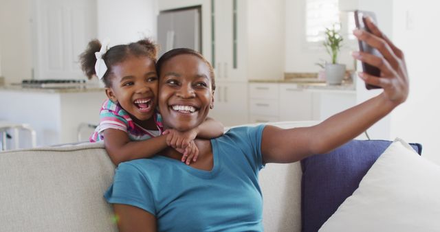 Happy african american mother and daughter taking selfie at home - Download Free Stock Photos Pikwizard.com