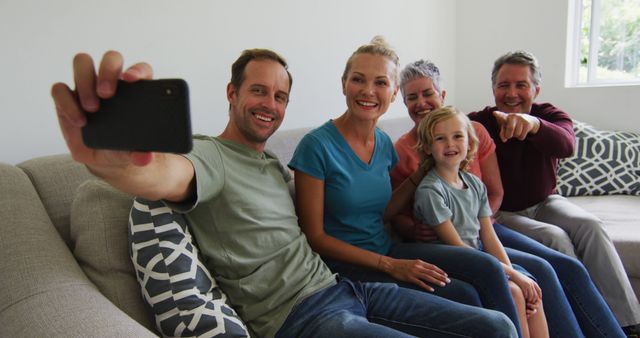 Three generation caucasian family taking a selfie together with smartphone at home - Download Free Stock Photos Pikwizard.com