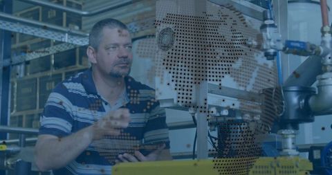 Industrial technician interacting with machinery and digital interface