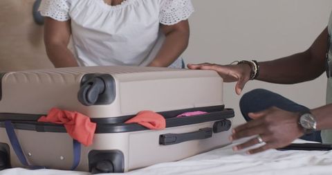 Friends Packing Suitcase for Exciting Travel Adventure