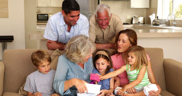 Family of three generations enjoying time together indoors, illustrating strong family bonds and happiness. Ideal for use in advertisements, family-oriented product promotions, lifestyle articles, and home-focused content.