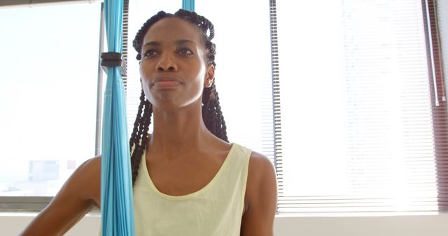 Focused Woman Practicing Aerial Yoga in Sunlit Studio - Download Free Stock Images Pikwizard.com