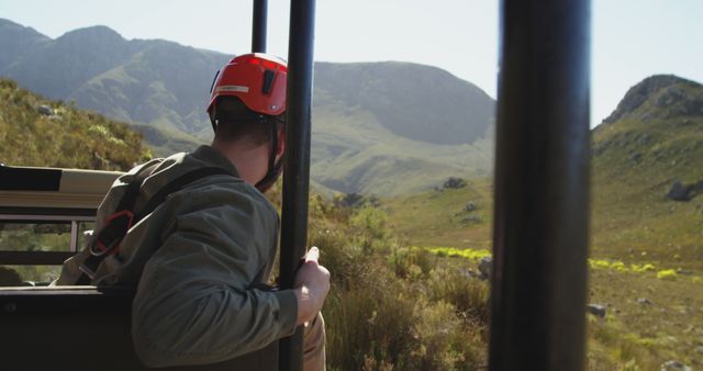 Adventurer Wearing Helmet On Safari Observing Wildlife In Mountains - Download Free Stock Images Pikwizard.com