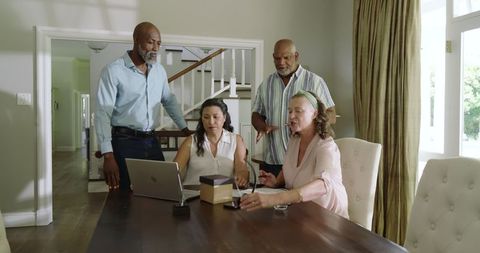 Senior Friends Gathering for Gift Exchange at Home Celebration
