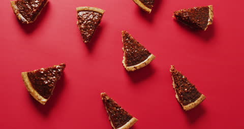 Slices of Pecan Pie Arranged Against Vibrant Red Backdrop