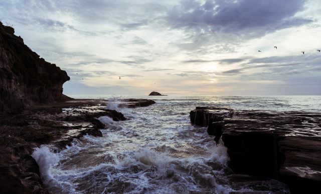 Majestic Ocean Waves Crashing Against Rocky Coastline at Sunrise - Download Free Stock Photos Pikwizard.com
