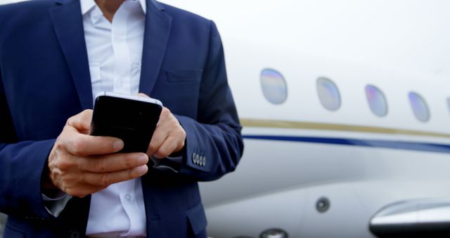 Mid section of businessman using mobile phone on a runway 4k