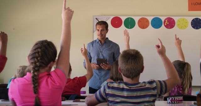 Young Teacher Engaging with Students in Classroom - Download Free Stock Images Pikwizard.com