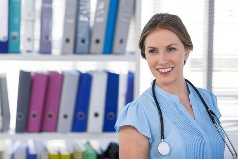 Confident female doctor smiling in modern clinic setting
