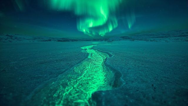 Aurora Borealis Glowing Over Illuminated Ice Crack in Arctic Tundra