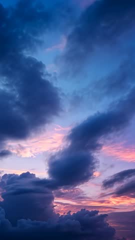 Vertical Twilight Skyscape Showing Shifting Cumulus Clouds Drifting Over Pink Horizon