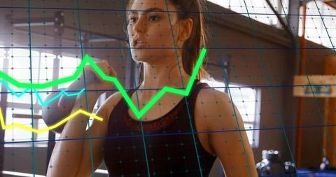 Young Woman Lifting Kettlebell in Gym with Digital Graph Overlay Tracking Fitness Progress