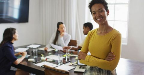Confident Businesswoman in Modern Office with Team Collaboration