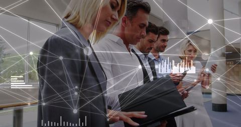 Diverse Professionals Analyzing Data with Digital Interface