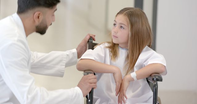 Doctor Assisting Young Girl in Wheelchair in Hospital - Download Free Stock Images Pikwizard.com