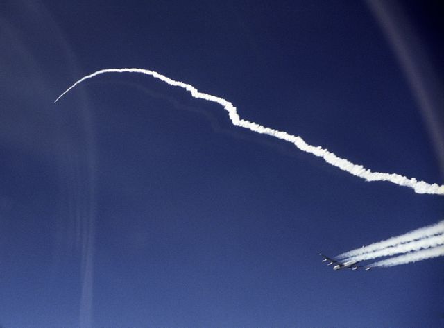 X-43A hypersonic research aircraft follows a distinctive vapor trail while carrying the Pegasus booster rocket after launch from a NASA B-52B aircraft over the Pacific Ocean. Capture moment on March 27, 2004, originating from NASA Dryden Flight Research Center. Useful for content on aerospace research, hypersonic technology, military aviation, and historical NASA missions.