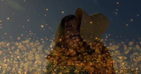 Romantic Silhouette of Woman with Hat and Glowing Bokeh Dusk Scene