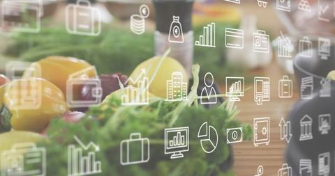 Overlaying finance icons on fresh peppers, greens and lemon on rustic wooden counter