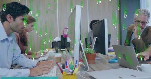 Diverse Team Analyzing Data with Modern Technology in Office