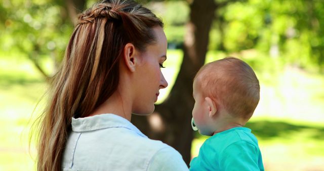 Mother Holding Baby Outdoors in Sunny Park - Download Free Stock Images Pikwizard.com