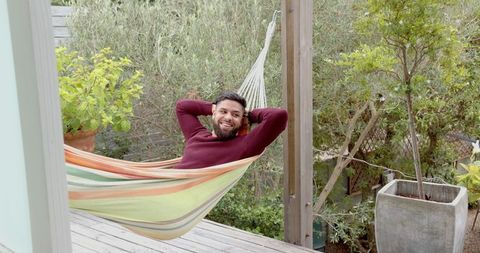 asian man relaxing in outdoor hammock surrounded by nature - Download Free Stock Images Pikwizard.com