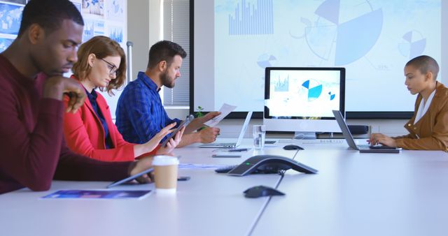 Diverse business team working in modern conference room analyzing data - Download Free Stock Images Pikwizard.com