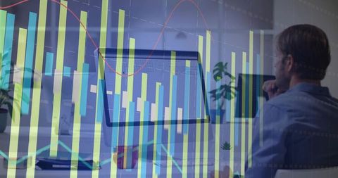 Professional analyzing data on computer with graph overlay